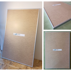 May include: A silver framed picture frame with a brown backing. The frame has a sticker on it that says "wall bonito".