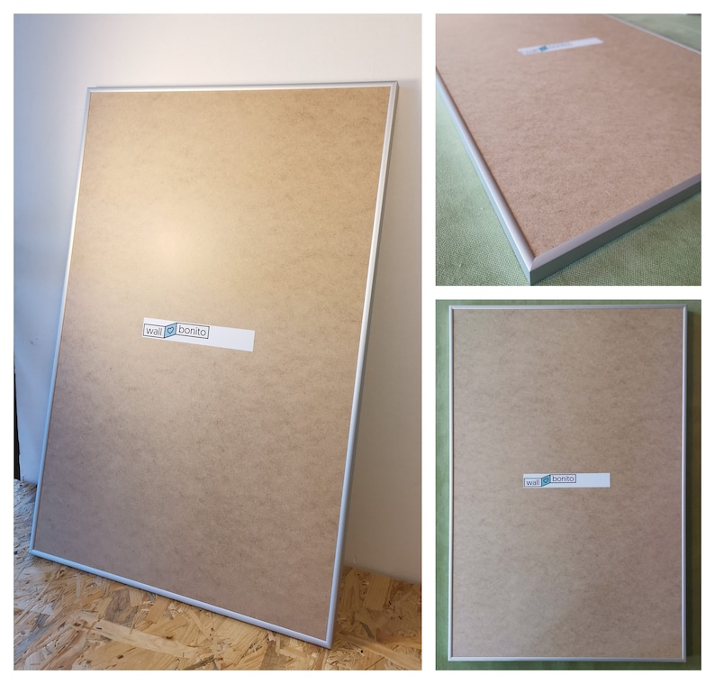 May include: A silver framed picture frame with a brown backing. The frame has a sticker on it that says "wall bonito".