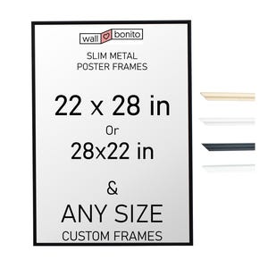 Könnte beinhalten: Ein rechteckiger schwarzer Metall-Posterrahmen mit dem Text wall bonito SLIM METAL POSTER FRAMES 22 x 28 in Or 28x22 in & ANY SIZE CUSTOM FRAMES. Rechts befinden sich vier dünne Rahmenprofil-Muster in Beige, Weiß, Schwarz und Silber.