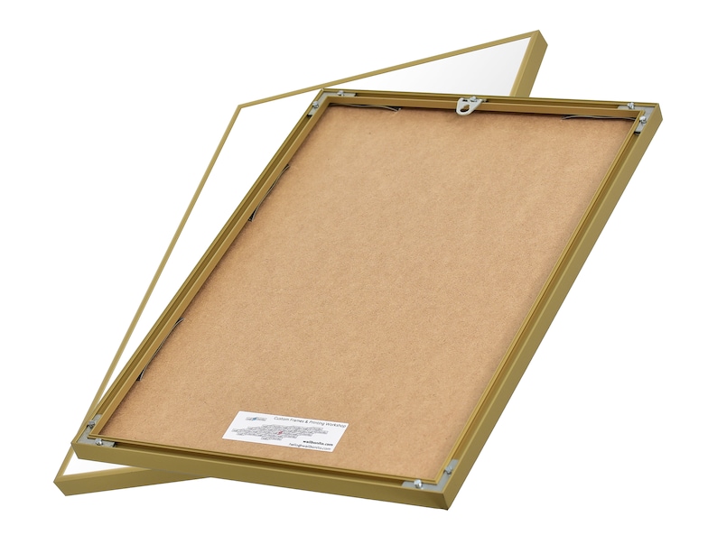 May include: A gold picture frame with a brown backing. The frame is open and the backing is visible. The frame is made of metal and has a simple design.