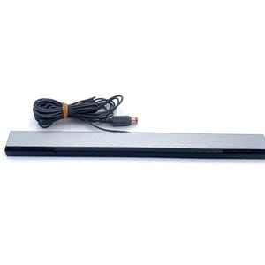 May include: A silver and black sensor bar with a black cable and connector. The cable is bundled with a brown rubber band. The sensor bar is a rectangular shape.