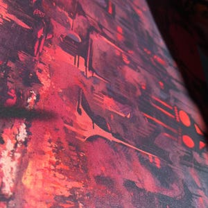 May include: Abstract painting with a red, pink, and black color scheme. The painting has a textured surface and appears to be made with layers of paint.