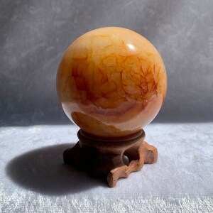 Bright Yellow Carnelian Sphere with Carved Wood Stand