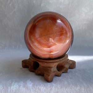 Polished Carnelian Sphere with Carved Wood Stand