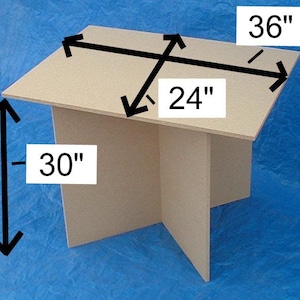 May include: A beige rectangular table with a cross-shaped base. The table features black arrows and text indicating dimensions of 36 inches in length, 24 inches in width, and 30 inches in height, providing clear measurements for the structure.