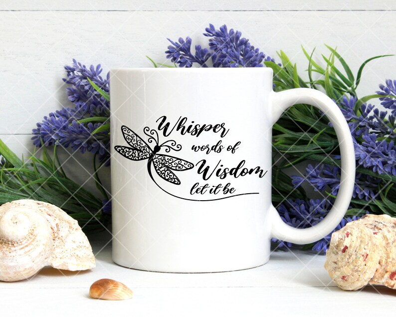 May include: White ceramic mug with a black dragonfly design and the text "Whisper words of Wisdom let it be".