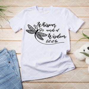 May include: White t-shirt with a black dragonfly design and the text "Whisper words of Wisdom let it be".