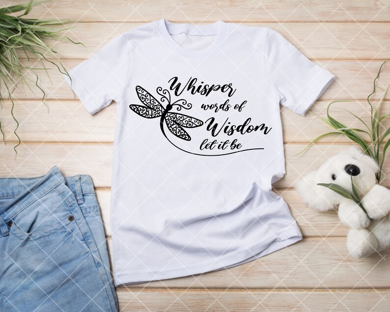 May include: White t-shirt with a black dragonfly design and the text "Whisper words of Wisdom let it be".