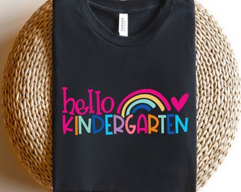 May include: Black t-shirt with the text "hello kindergarten" in colorful letters with a rainbow and a pink heart.