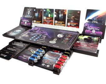 May include: A black and purple board game with a variety of cards and tokens. The game is called "Nemesis" and features a futuristic space theme. The game includes a variety of cards, tokens, and miniatures.