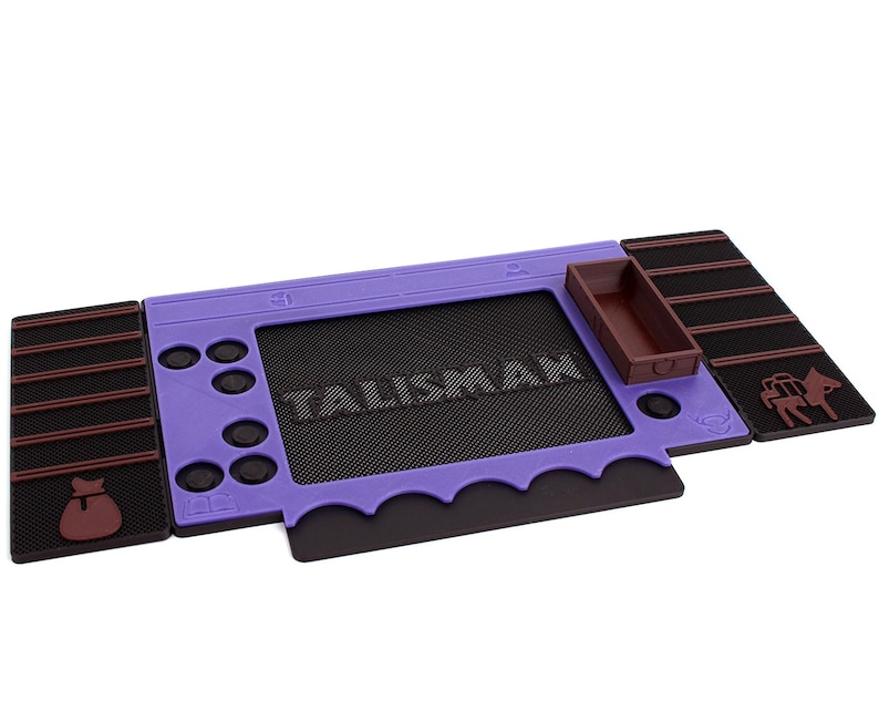 Pu&ograve; includere: Un tappetino da gioco in gomma viola e marrone con la parola "Talisman" stampata su di esso. Il tappetino ha un piccolo vassoio marrone e una piccola figura marrone di un asino.