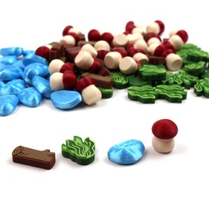 May include: A collection of colourful game pieces including red and white mushrooms, brown logs, green leaves, and blue water drops.