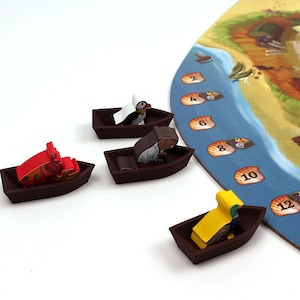May include: Four small wooden boats with different animal figures on top. The boats are brown and the animals are red, white, yellow, and brown. The boats are on a white surface and there is a game board in the background with numbers 2 through 14.
