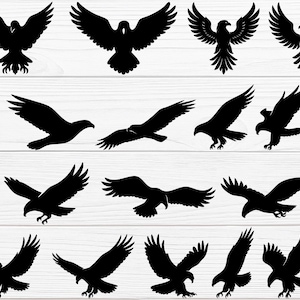 Op de afbeelding: Een verzameling zwarte adelaarsilhouetten in verschillende poses, waaronder zwevend, zittend en in vlucht. De afbeeldingen staan tegen een witte achtergrond met houtnerf, wat een sterk contrast oplevert.
