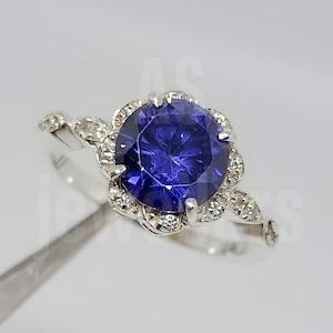 Halo Tanzanite Ring: 925 Sterling Silver, CZ Diamond Accents
