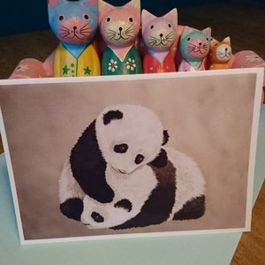 Dois lindos pandas em um cartão postal