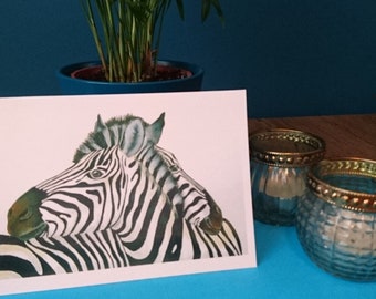 Een wenskaart met twee knuffelende zebra's