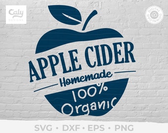 Puede incluir: Un gráfico de manzana azul con el texto "APPLE CIDER" en una pancarta blanca, "Homemade" en una pancarta blanca más pequeña y "100% Organic" en una pancarta blanca. El gráfico está sobre un fondo de ladrillo blanco.