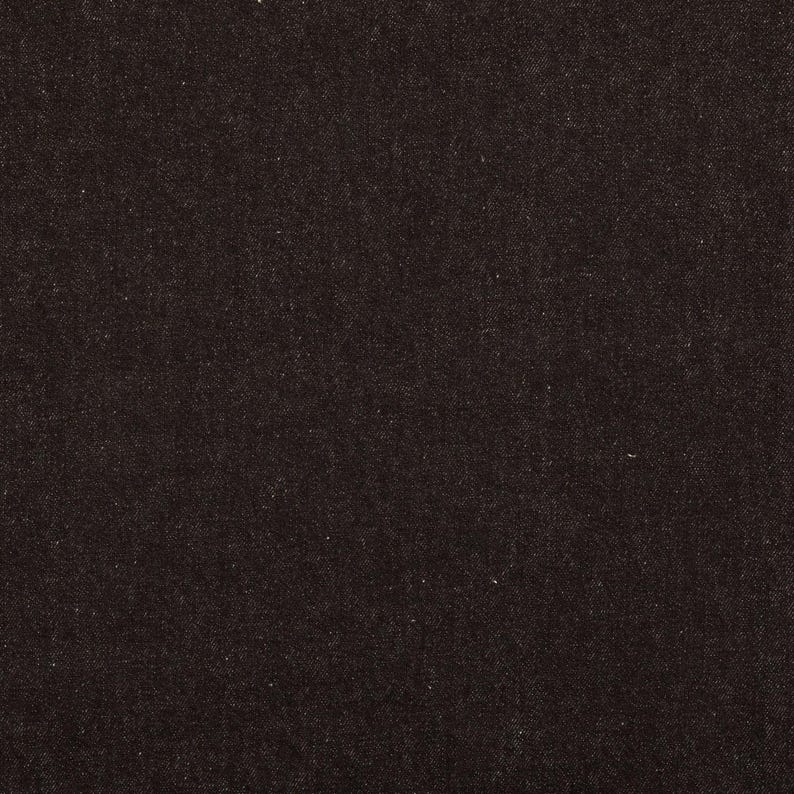 May include: Close-up of a dark brown fabric with a subtle, textured weave. The material appears to be a dense textile, possibly denim or a similar sturdy cloth. The color is a deep, solid shade.