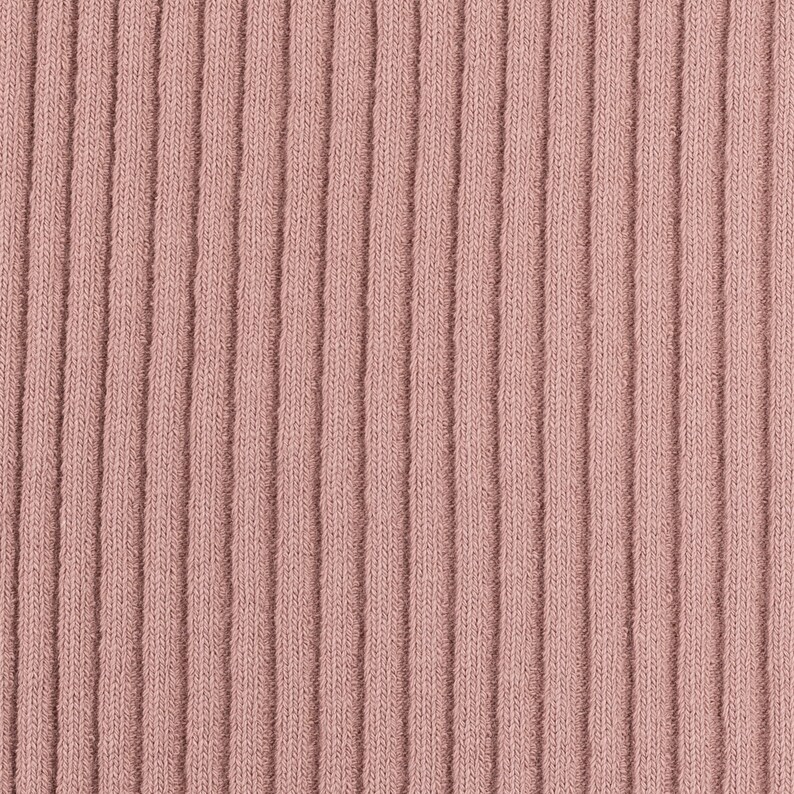 May include: Close-up of a ribbed fabric in a dusty rose color. The fabric has a vertical texture and a soft, smooth appearance.