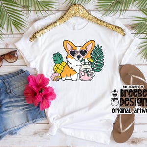 May include: White t-shirt with a cartoon image of a corgi wearing sunglasses and holding a pineapple and a glass of pink lemonade. The text "Exclusively at Breebee Designs Original Artwork" is printed on the bottom right corner of the shirt.