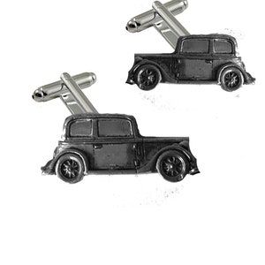 May include: A pair of silver cufflinks featuring a vintage car design. The car is made of pewter and has a black finish.