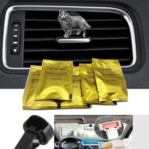 May include: A set of car vent clips with air fresheners. The clips are black and white and the air fresheners are gold with Chinese text and English text that says "Peach Flavor", "Lavender", and "Lemon".