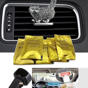 May include: A set of car vent clips with a silver cat figurine, and four gold air freshener sachets with Chinese text. The sachets are labeled "Peach Flavor", "Lemon", and "Lavender".