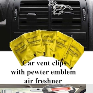 May include: Five yellow car air freshener vent clips with different scents: Peach Flavor, Tropical Fine, Lemon Flavor, Lavender, and Storm Shower. The clips are attached to a pewter horse emblem.