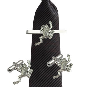 May include: A black striped tie with a silver frog tie clip and a pair of silver frog cufflinks.