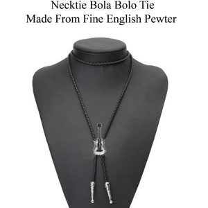 May include: Black bolo tie with a silver guitar pendant. The tie is made from fine English pewter.