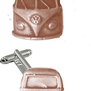 May include: A pair of silver cufflinks featuring a vintage Volkswagen bus in a brown finish. The bus is shown from the front and back.