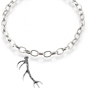 May include: A silver chain bracelet with a silver antler charm. The chain is made of oval links.