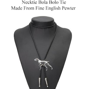 May include: A black leather bolo tie with a silver-toned pendant featuring a detailed dog figurine. The tie is displayed on a black mannequin bust. "Check out my range of Necklace Necktie Bola Bolo Tie Made From Fine English Pewter" is written in white text above the tie.
