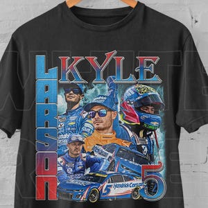 May include: Black t-shirt featuring a graphic of Kyle Larson, a race car driver, with the text "KYLE LARSON 5". The design includes images of Larson, a race car, and the number 5 in blue and red.