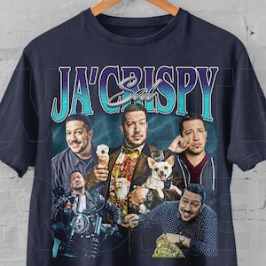 May include: A navy blue t-shirt with a vintage-style graphic featuring four men and a dog. The graphic says "Ja'Crispy Sal".