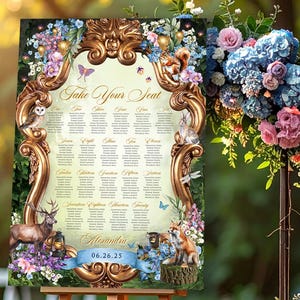 May include: A wooden easel displays a wedding seating chart with a gold ornate frame. The chart features a floral and woodland animal design, with the text "Take Your Seat" at the top and the date "06.26.25" at the bottom. The scene is set outdoors.