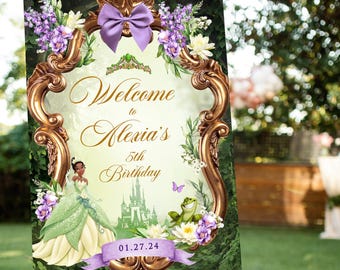 May include: A wooden easel displays a welcome sign for Alexia's 5th birthday. The sign features a gold frame, a purple bow, and illustrations of a princess, a frog, and a castle. The date 01.27.24 is also displayed. Purple roses and greenery adorn the easel.