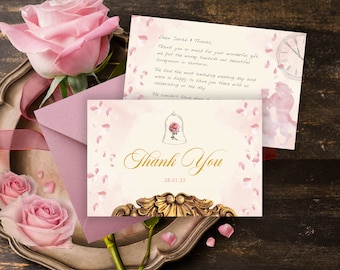May include: A thank you card with a gold and white design featuring a glass dome with a rose inside. The card has a pink watercolour background with pink rose petals scattered across it. The text "Thank You" is written in gold script with the date "28.01.23" below it.