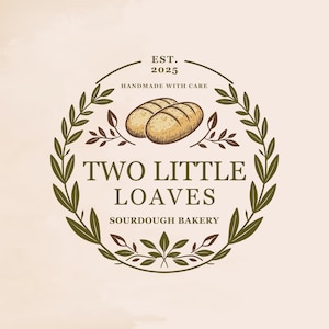 May include: A logo for a sourdough bakery called "Two Little Loaves" established in 2025. The logo features a wreath of green leaves with two loaves of bread in the center. The text "Handmade with Care" is above the bread and "Sourdough Bakery" is below.