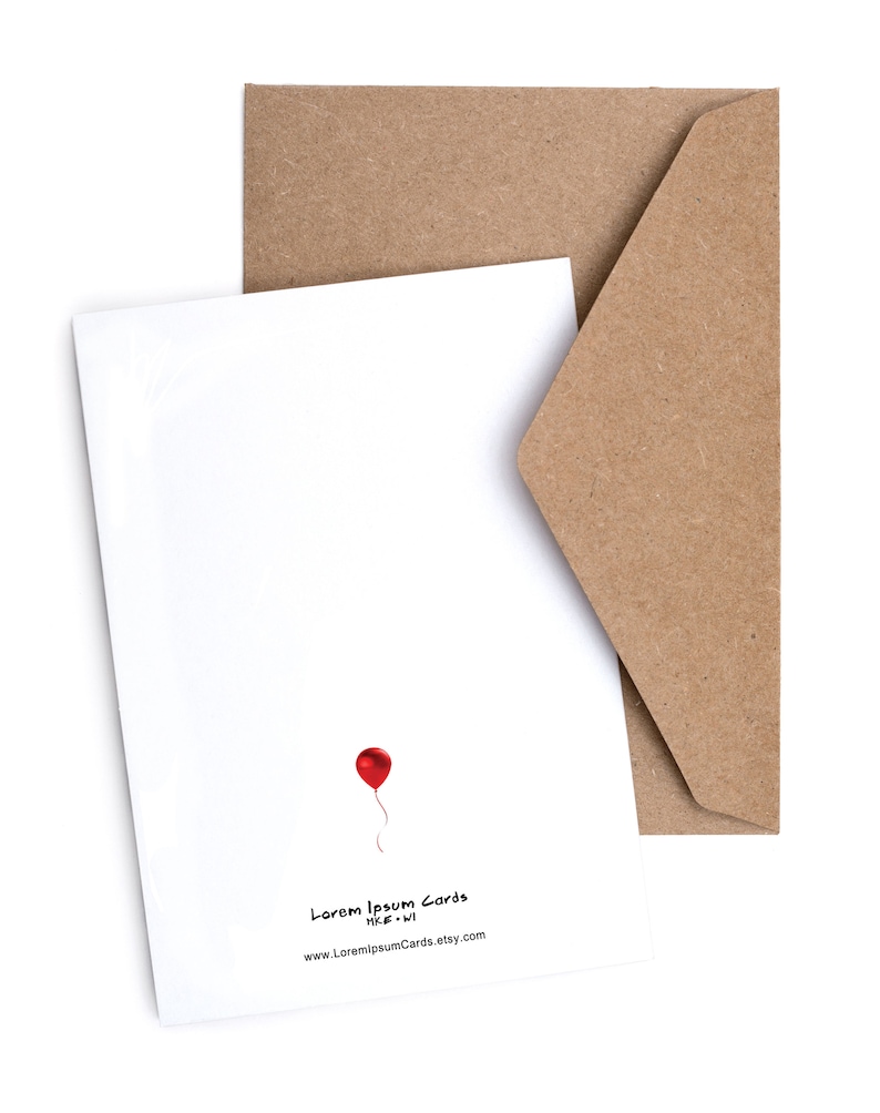 May include: A blank white card with a red balloon and the text "Lorem Ipsum Cards" and "www.LoremIpsumCards.etsy.com". The card is sitting on a brown envelope.