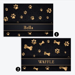 May include: Two rectangular black cards with a dark damask pattern and gold accents. The first card features gold paw prints and the name Bella. The second card displays gold paw prints and bones with the name WAFFLE in gold lettering.