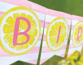 May include: A pink and white striped banner with lemon slices and the word "BIRTHDAY" written in pink letters.