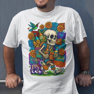 May include: White t-shirt featuring a colorful illustration of a skeleton carrying bottles and a dog. The design includes flowers, a hummingbird, and the text "Love for Our Roots".