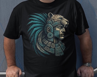 May include: Black t-shirt featuring a detailed illustration of an Aztec warrior with a jaguar headdress, turquoise feathers, and geometric designs. The artwork is centered on the shirt, showcasing the warrior's profile. The shirt is worn by a person.