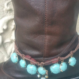May include: Brown leather boots with a turquoise and gold beaded ankle bracelet.