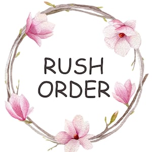 May include: A watercolor illustration of a wreath made of branches with pink magnolia flowers. The wreath has the text "Rush Order" in the center.