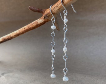 Swinging white pearl and silver link dangle earrings. Sustainably sourced materials and handmade to order.