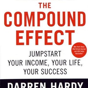 May include: Book cover with a red title "The Compound Effect" and the subtitle "Jumpstart Your Income, Your Life, Your Success". The author is Darren Hardy, publisher of SUCCESS magazine. The book is a New York Times, Wall Street Journal, and USA Today bestseller.