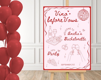 May include: A pink sign on an easel with red text that reads "Vino before Vows" and "Welcome to Amelia's Bachelorette". The sign has illustrations of wine, cheese, and a disco ball. Red balloons are on the left.